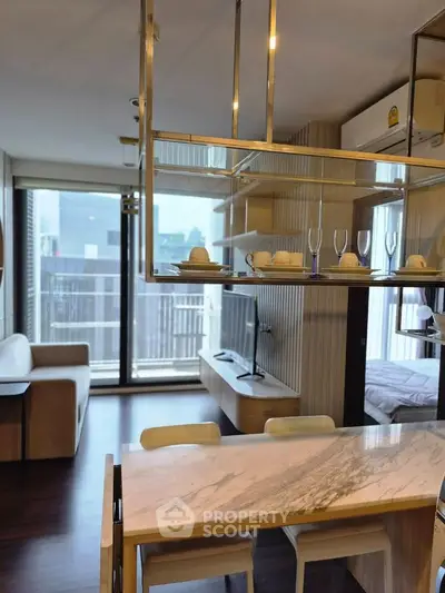 Modern open-plan living room with stylish dining area and large windows in a contemporary apartment.