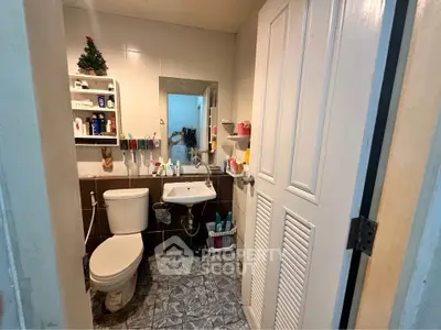 Cozy bathroom with modern fixtures and ample storage space.