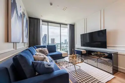 Luxurious modern living room with city view, featuring plush blue sofas and a large flat-screen TV.