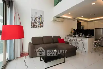 Modern living room with stylish decor and open kitchen layout in a contemporary apartment.