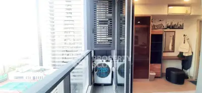 Modern apartment balcony with city view and washing machine