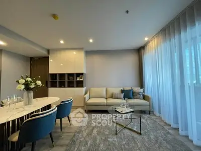 Modern living room with elegant decor and large windows in a stylish apartment.
