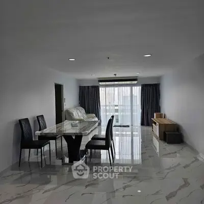 Spacious modern living room with elegant marble flooring and stylish dining area.