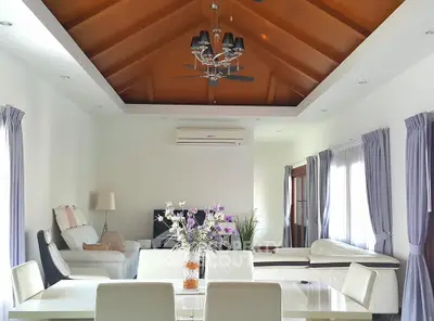 Spacious living room with vaulted ceiling and elegant decor