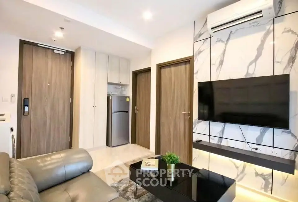 Modern living room with marble accent wall, sleek furniture, and built-in air conditioning.