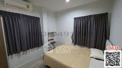 Cozy bedroom with modern air conditioning and stylish curtains, perfect for comfort and relaxation.