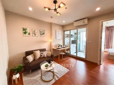 Modern living room with cozy sofa, stylish decor, and open kitchen layout in a chic apartment.