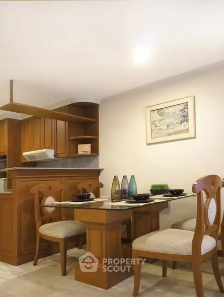 Charming kitchen with wooden cabinetry and elegant dining set, perfect for cozy meals.