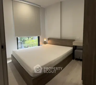 Modern minimalist bedroom with large window and wooden furniture