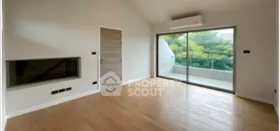 Spacious living room with large windows and balcony view