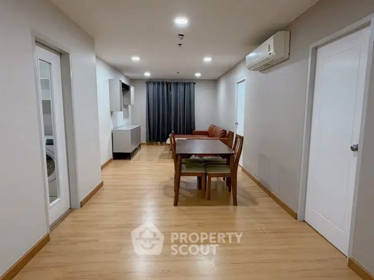 Spacious living room with modern dining set and air conditioning