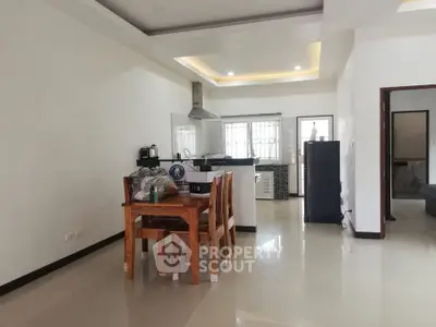 Spacious open-layout kitchen and dining area with modern appliances and natural lighting.