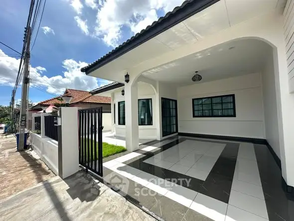 Modern single-story house with spacious driveway and stylish exterior design.