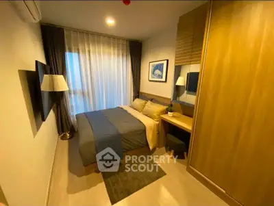 Cozy modern bedroom with stylish decor and ample natural light