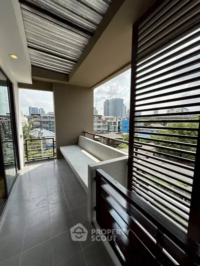 Spacious balcony with city view in modern apartment