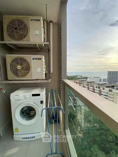High-rise balcony with washing machine and scenic city view