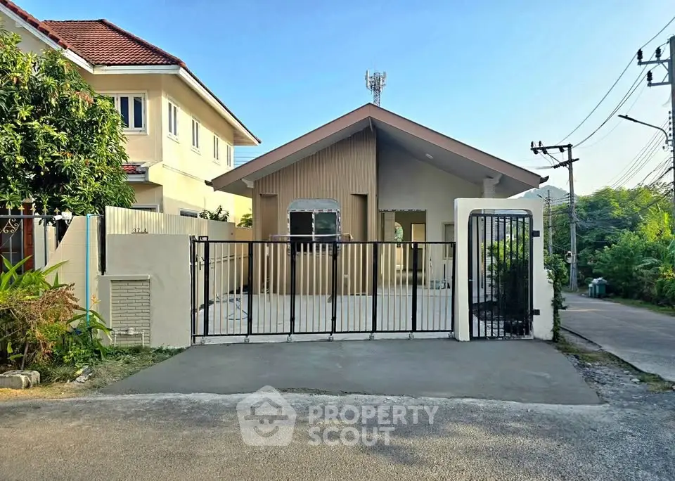 Charming single-story house with gated entrance and modern exterior design in a serene neighborhood.