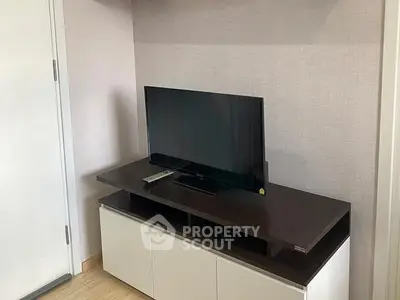 Modern living room with sleek TV stand and flat-screen television