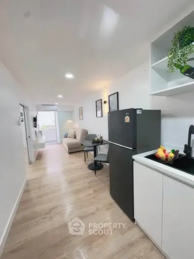 Modern open-plan kitchen and living area with sleek design and natural light.