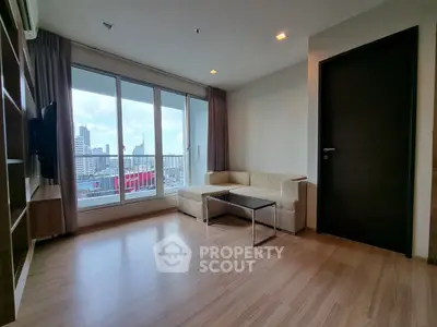 Spacious living room with city view and modern furnishings in high-rise apartment