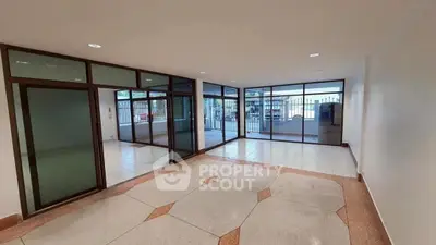 Spacious open-plan living area with large windows and modern design