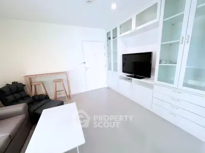 Modern living room with sleek built-in cabinets and cozy seating area.