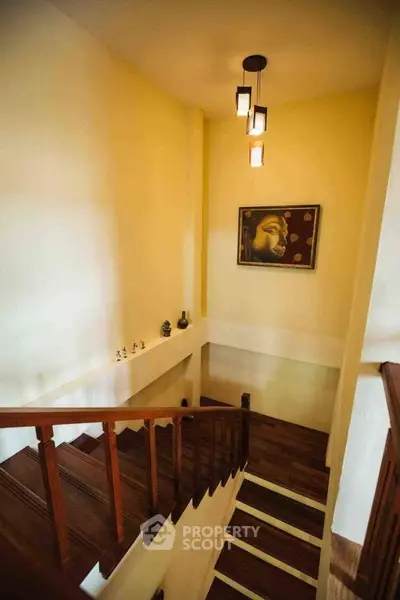 Elegant staircase with wooden steps and modern lighting in a stylish home interior.