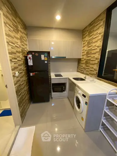 Modern kitchen with sleek appliances and stylish backsplash