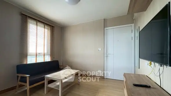 Modern living room with minimalist furniture and wall-mounted TV