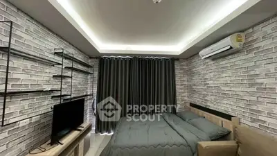 Modern bedroom with exposed brick walls and sleek furnishings