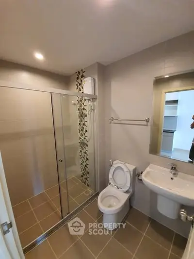 Modern bathroom with glass shower and sleek fixtures