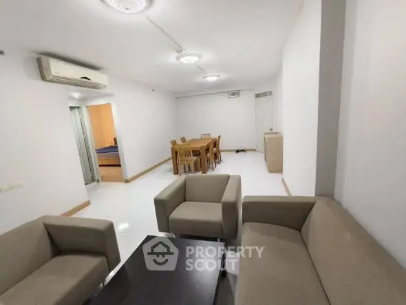 Spacious living room with modern furniture and dining area, perfect for family gatherings.