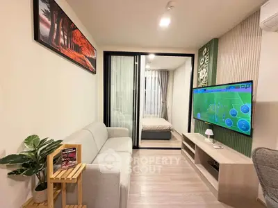 Modern living room with sleek design, featuring a cozy sofa, wall-mounted TV, and sliding glass doors to bedroom.