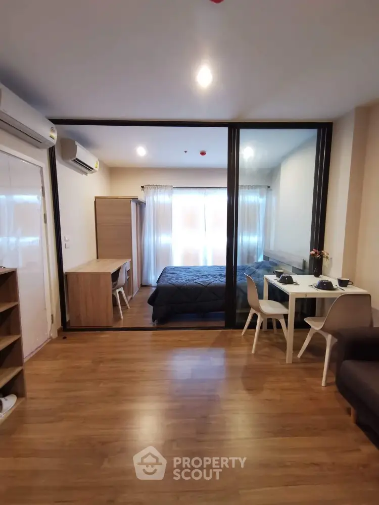 Modern studio apartment with wooden flooring and stylish furniture