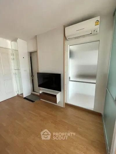 Modern living room with sleek TV setup and air conditioning