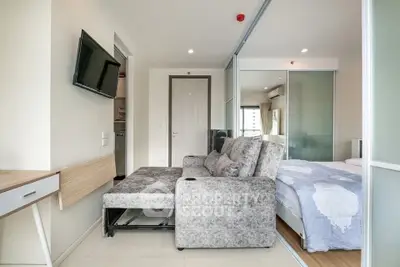 Modern apartment interior with cozy living room and bedroom, featuring stylish furniture and natural light.