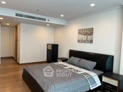 Spacious modern bedroom with elegant decor and wooden flooring