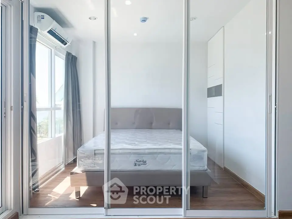 Modern bedroom with large windows and sleek design