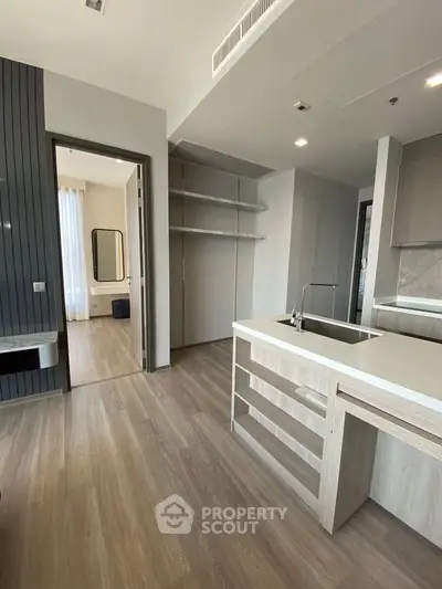 Modern kitchen with open layout and sleek design, featuring a spacious island and ample storage.