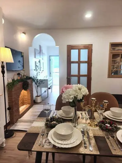 Charming dining room with elegant table setting and cozy fireplace in a stylish home interior.