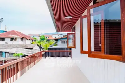 Spacious balcony with wooden accents and scenic neighborhood view