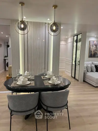 Elegant modern dining area with stylish lighting and luxurious decor in a contemporary apartment.
