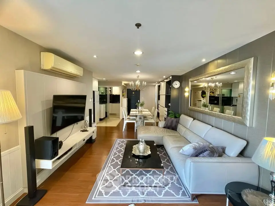 Spacious modern living room with elegant decor and open layout, featuring a large sectional sofa and stylish dining area.