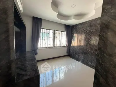 Elegant modern room with marble walls and large window, perfect for stylish living.