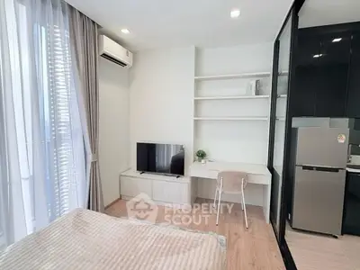 Modern bedroom with sleek design, featuring a built-in desk, TV, and large window for natural light.