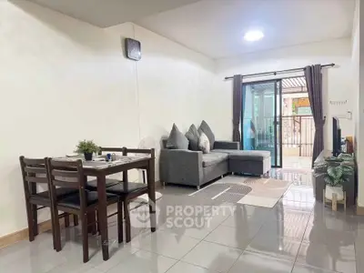 Spacious living room with modern decor and balcony access in a stylish apartment.