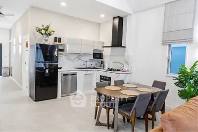 Modern kitchen with sleek appliances and dining area in open layout design