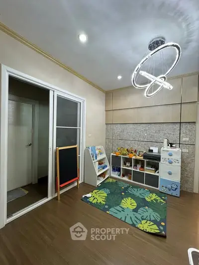Charming playroom with modern lighting and ample storage, perfect for family living.
