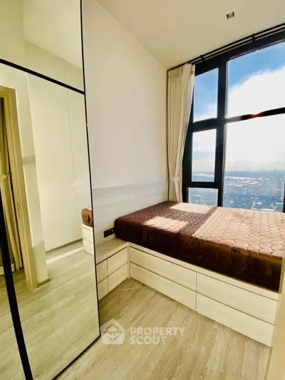 Modern bedroom with floor-to-ceiling windows and stunning city view