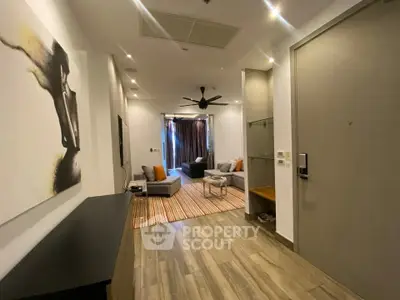 Modern living room with stylish decor and open layout, featuring cozy seating and contemporary artwork.